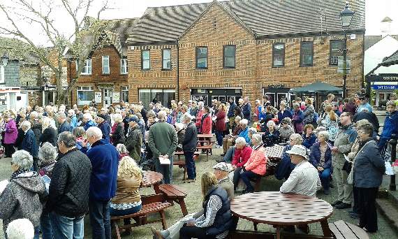 The Walk of Witness stops to pray and sing in the Market Square