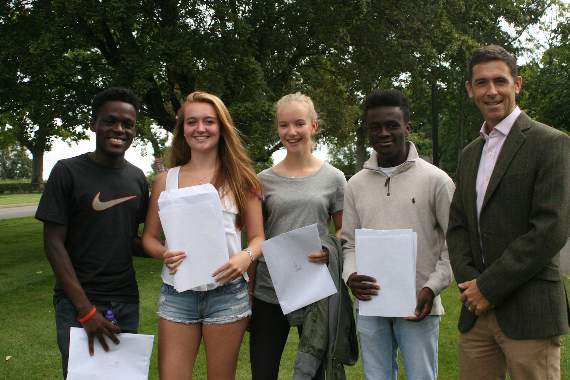 Headteacher Adam Williams (right) with students Melvin Boateng, Mackenzie Burke, Tabitha Restall-Young, and Alvin Boateng
