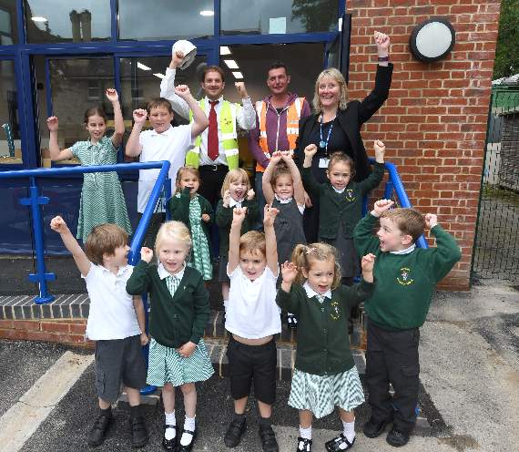 Building success: Headteacher Katy Pinchess, pupils and  representatives of Linden Homes celebrate the completion of ‘The Big School Build’ project