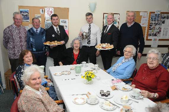 Members of staff from Old Thorns serving afternoon tea to elderly guests at Liphook Day Centre
