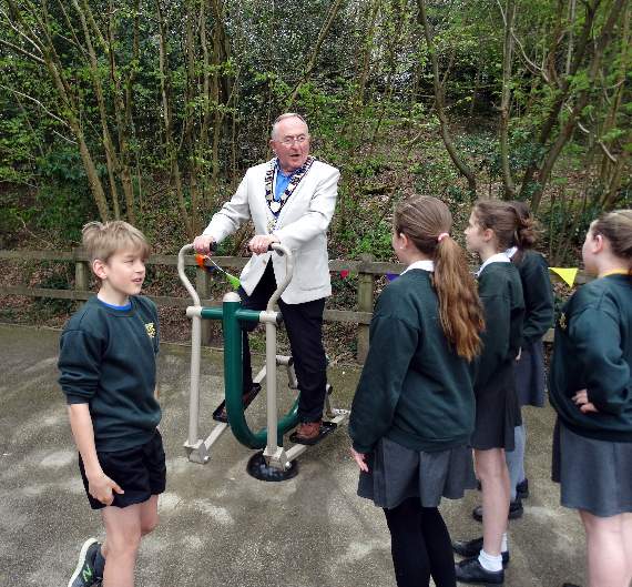 Mayor Malcolm Carter chats with pupils at Shottermill Junior School while trying out the new playground
