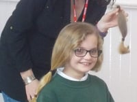 Caring Maddison lops her long locks for charity