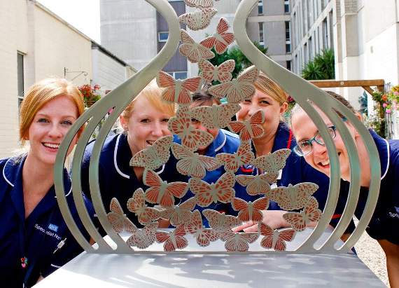 Nurses admiring the Hourglass of Butterflies sculpture at North Hampshire Hospital. PICTURE: HOSPITAL ART STUDIO