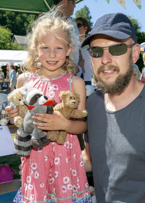 Florrie and dad with the prizes she won on the Teddy Tombola (HD28-296-18)