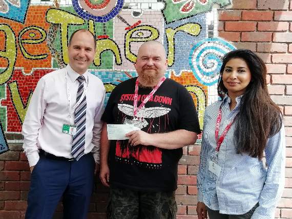 Joel Corey, centre, and Rosina Mann presented the cheque to David Jackson
