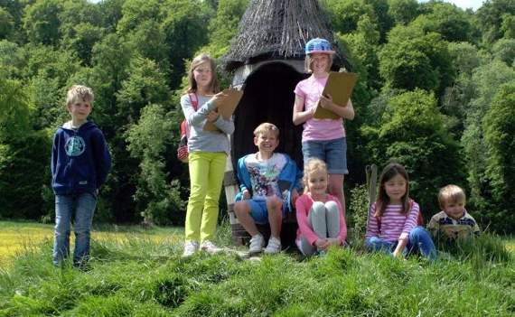 Children with explorer backpacks in the garden of Gilbert White’s House