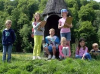 Children with explorer backpacks in the garden of Gilbert White’s House