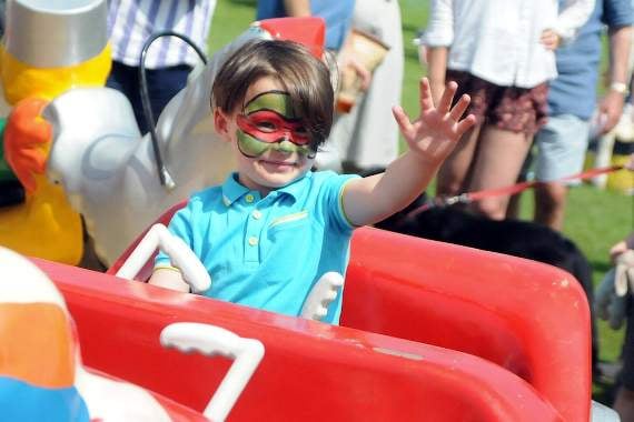 <p>A young boy having fun on the fairground rides  at Brook Fete (HD23-59-18)</p>