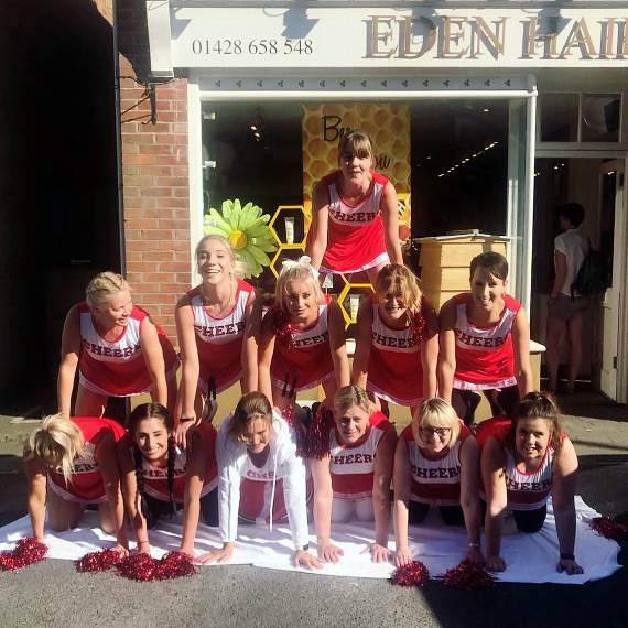Staff from Eden Hair and Beauty dressed as cheerleaders as they raised cash for Camelsdale School