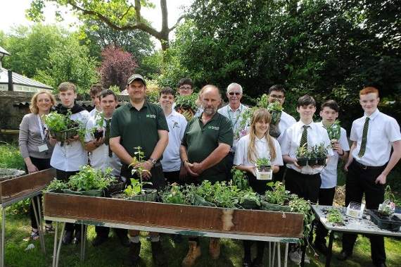 Farnham Town Council staff teaching pupils at The Abbey School how to make hanging baskets. Picture order no: FD25-57-18