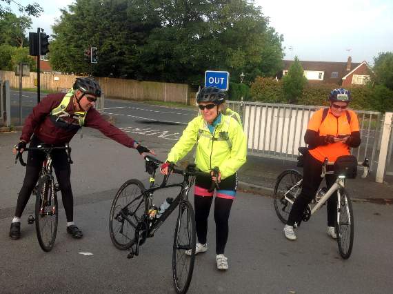 And she’s done it! Sue (centre) dismounts her bike after 235 long miles across multiple counties