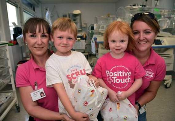 Riley and Emily with staff at Royal Surrey County Hospital’s special care baby unit promoting Positive Touch