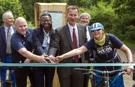 The Tory MP cuts the ribbon at the Cycle Surrey Hills launch (HD25-353-18)