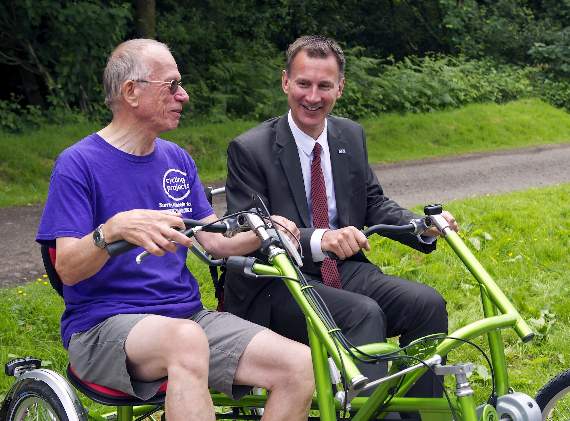 In the driving seat: Health Secretary Jeremy Hunt with Roy Benson (left) (Picture order no.HD25-354-18)