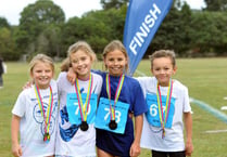 Triathletes swim, cycle and run to finish line