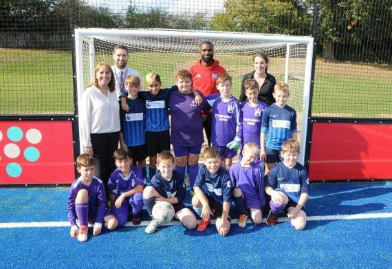 Youngsters from William Cobbett Primary School are joined by Aldershot Town footballer Karleigh Osborne at the unveiling of the new artificial pitch. Picture order no: FD42-34-18