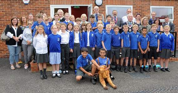 Pupils and guests including Camelsdale’s mascot Humphrey the camel celebrating the school’s new cafe’s opening (HD39-08-18)