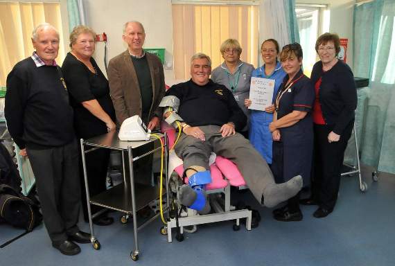 Alton Rotarian Keith Arrowsmith-Oliver tries out the new machine, overseen by hospital staff and fellow club members