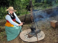 Julie Walker in period costume by the kettle warmed over the fire (HD39-95-18)