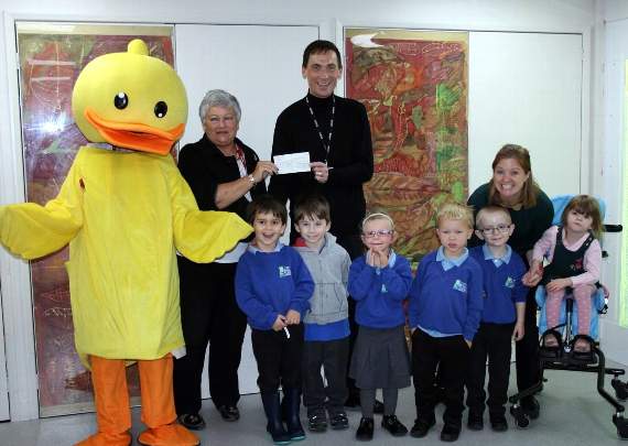Farnham Weyside president Diane Vasey presents the cheque to Darryl Morgan, headteacher of Ridgeway School