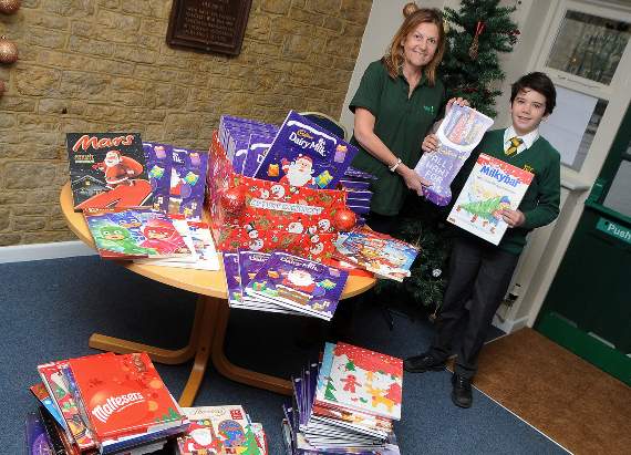 Max Moon presented the Advent calendars to volunteer Mel Cracknell on Tuesday. Picture order no: FD49-140-18