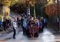 Piper leads village youth on march to memorial