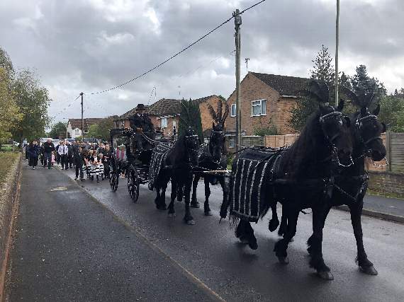 A horse-drawn hearse and procession made its way through Bordon