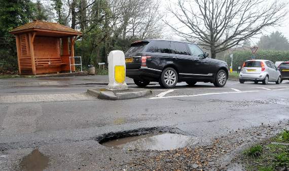 <p>A potholed road in Surrey</p>