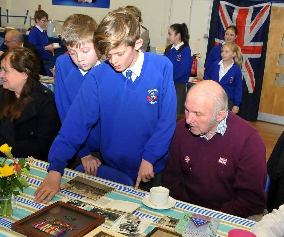 Students viewed a collection of medals and photographs during the tea party (Picture order no: FD09-06-19)