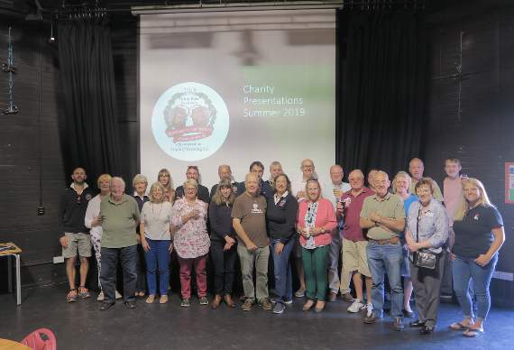 Beer festival volunteers met charity representatives at Alton College for Saturday’s handover