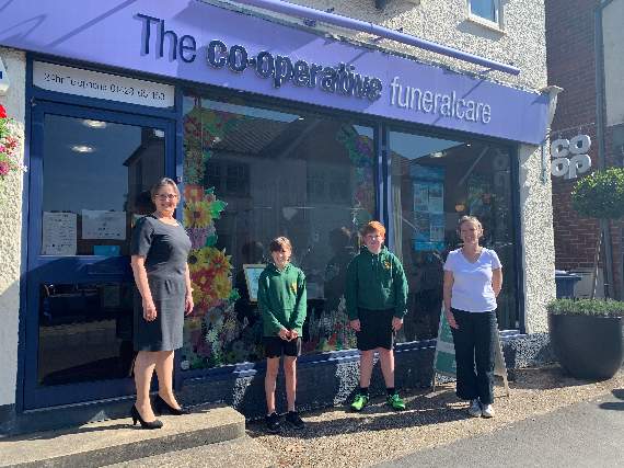 Co-operative funeral arranger Ingrid Collins with Shottermill Junior School head girl Clorie Buckrell (left) and head boy Adam Wray (right), both aged 11 and school art teacher Olivia Harmer