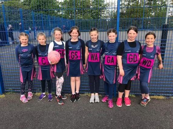 The Liphook netball team with their new kit  donated by housing company Taylor Wimpey