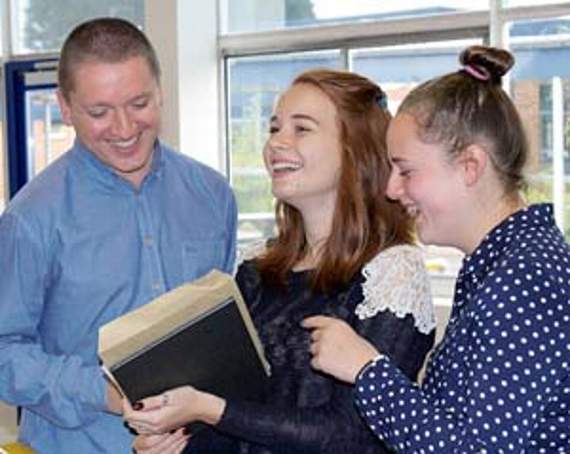 •Dean Academy deputy head Craig Burns with Molly Bishop and Teigan Black.
