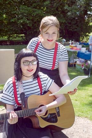 •Performers Emma (on guitar) and Rhiannon Hill rehearsing for the stage.