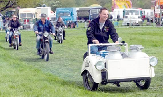 •Members of Forest of Dean Vintage Club with their motorbikes and a milk delivery bike in the foreground.