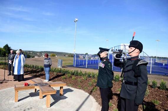 Rifleman Nathan Clark sounds Last Post with Lt Col Matthew Ford saluting.