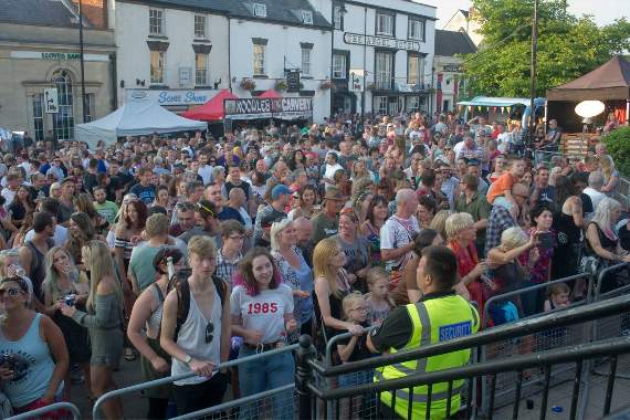 A large crowd in front of the main stage.