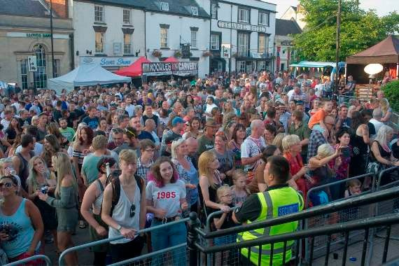 A large crowd in front of the main stage.