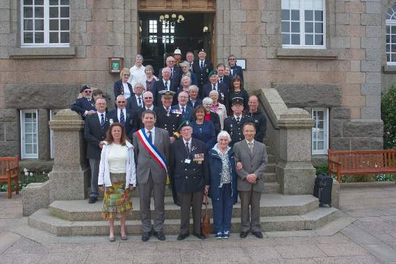 n The whole group pose for a photo at Perros Guirec Hotel de Ville (town hall) following a champagne reception. In front are Catherine Pontailler, Mayor Erven Leon, John Eskdale (RNA), Elsie George and Bernard Ernot.