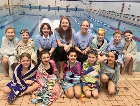 Tom’s sisters Emily and Holly with fellow organiser Katie Cameron and some of the swimmers at Monmouth Schools Pre-Prep and Nursery’s leg of the swimathon.