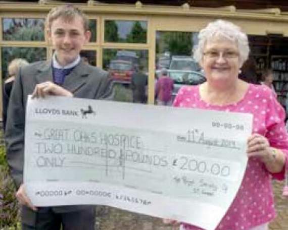 Jake Norris presents the cheque to Great Oaks founder Sheila Evans.