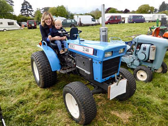 Bertie Gordon-Jones, aged 22 months, from Ruardean Woodside takes the wheel of a mini Iseki Impact tractor with mum Sarah.