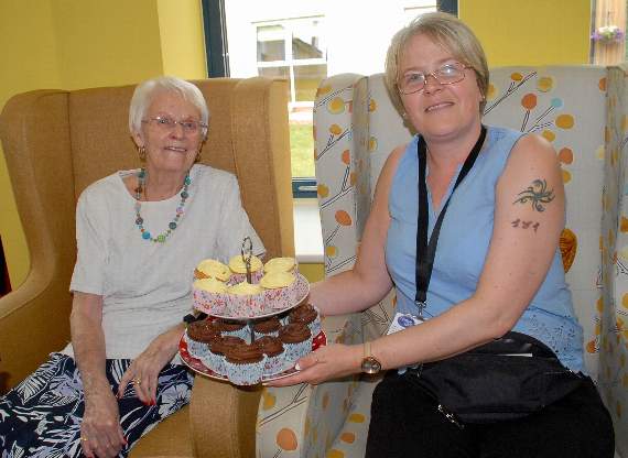 Wendy Jones offers Audrey Lee a scrumptious cake at the Dora Matthews House summer fayre.