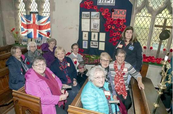 Members and supporters of Charlie’s Angels with some of the 219 poppies knitted for the occasion.