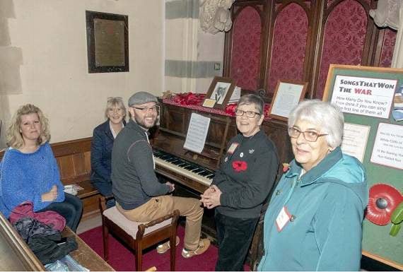 Gathered around the paino for Songs That Won the War were (from left) Ruth Ward, Judy Osborne, Thomas Wildin, Isobel Winstanley and Betty Weaver.