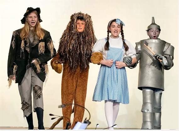 Off to meet the Wizard are Lily Salter as the Scarecrow, Wilfred Green as the Cowardly Lion, Connie Davies as Dorothy, and Ollie Taylor as the Tin Man.