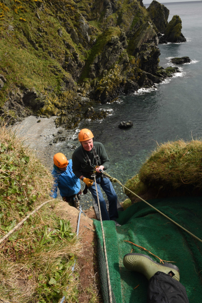 81-year-old Bob Keith completes a fundraising abseil off cliffs at Maughold in aid of Arthritis Care Isle of Man, with help from the Venture Centre -