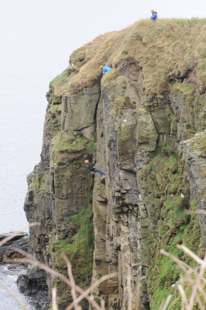 81-year-old Bob Keith completes a fundraising abseil off cliffs at Maughold in aid of Arthritis Care Isle of Man, with help from the Venture Centre -