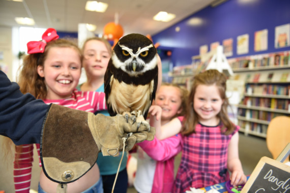 Owls from the Wildlife Park visit the Family Library in Douglas - left to right: Imogen Cowell (8), Holly Callow (8), Bugg the spectacled owl, Teigan Cowell (5) and Elisa Gerrard (6)