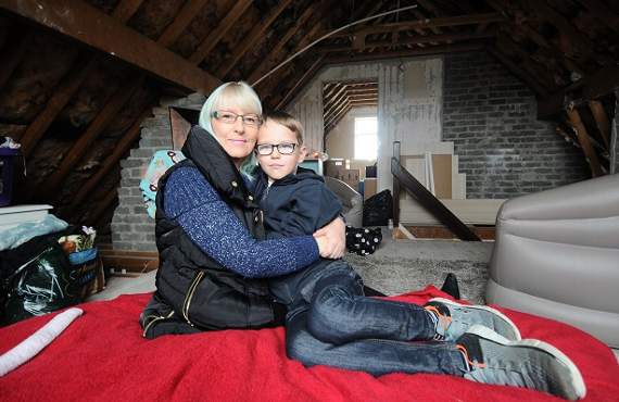 Lynn Bridson with Kayden Smith-Bridson (8) in Lynn's attic room. Lynn is Kayden's legal guardian